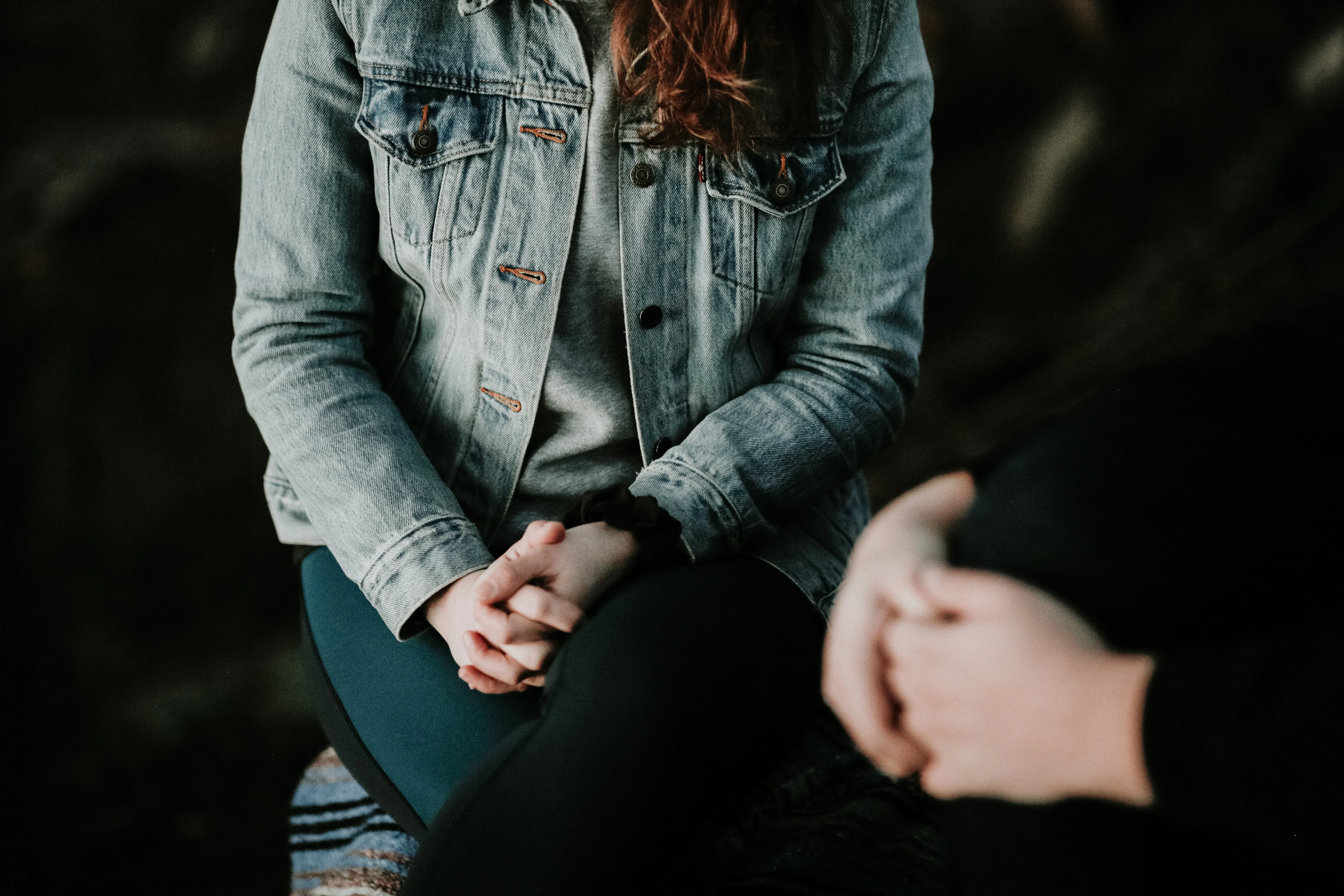 Person sitting with their hands on their lap