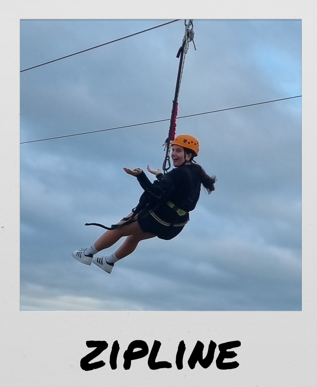 Polaroid image of a girl on a zipline, titled “Zipline”