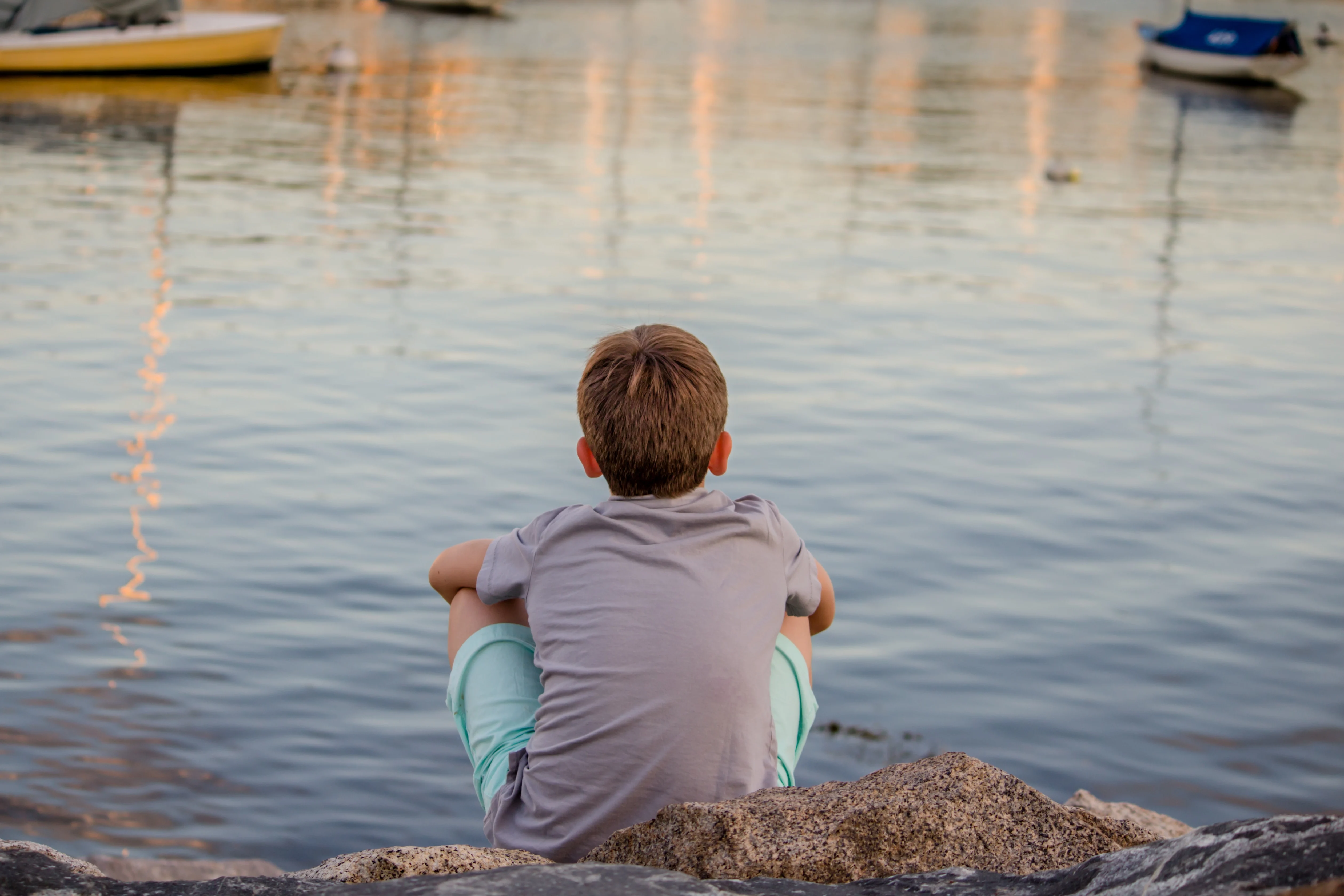 Child looking out at a lake