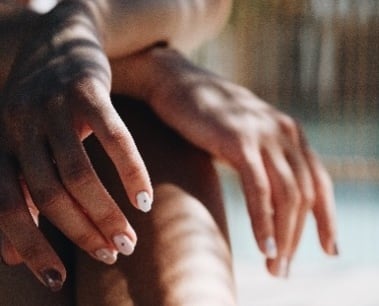 Close-up of two hands, one hand gently resting on top of the other