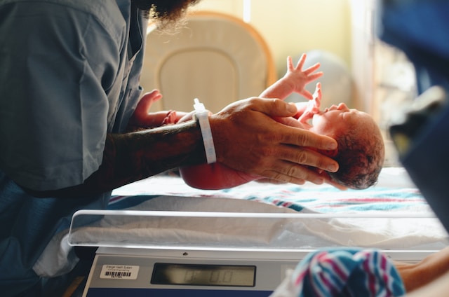 An infant being weighed